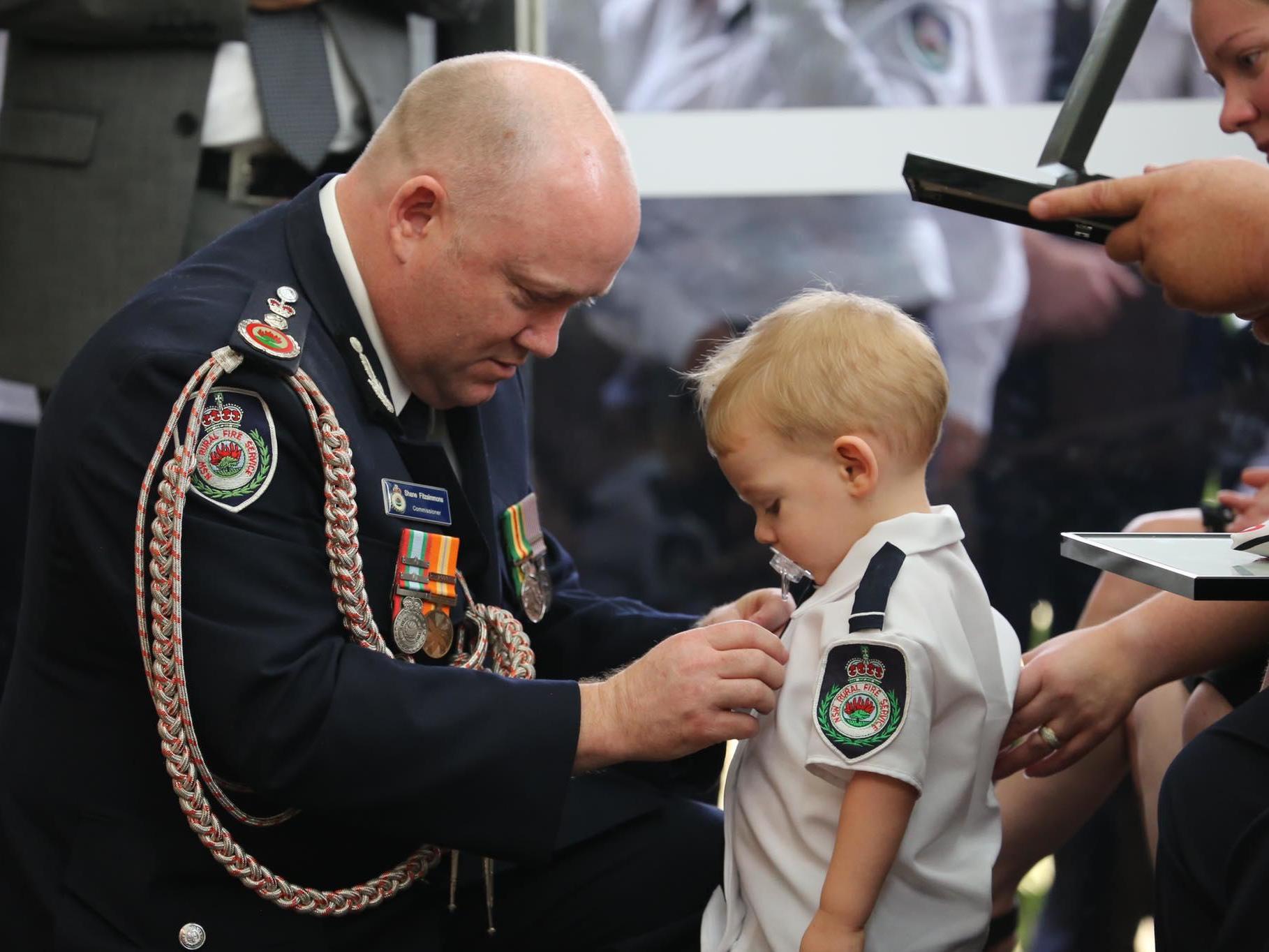 Harvey Keaton, aged 19 months, receives his father Geoffrey Keaton's posthumous bravery medal after the volunteer firefighter was killed on his way to tackle wildfires in New South Wales, Australia, 19 December, 2019.