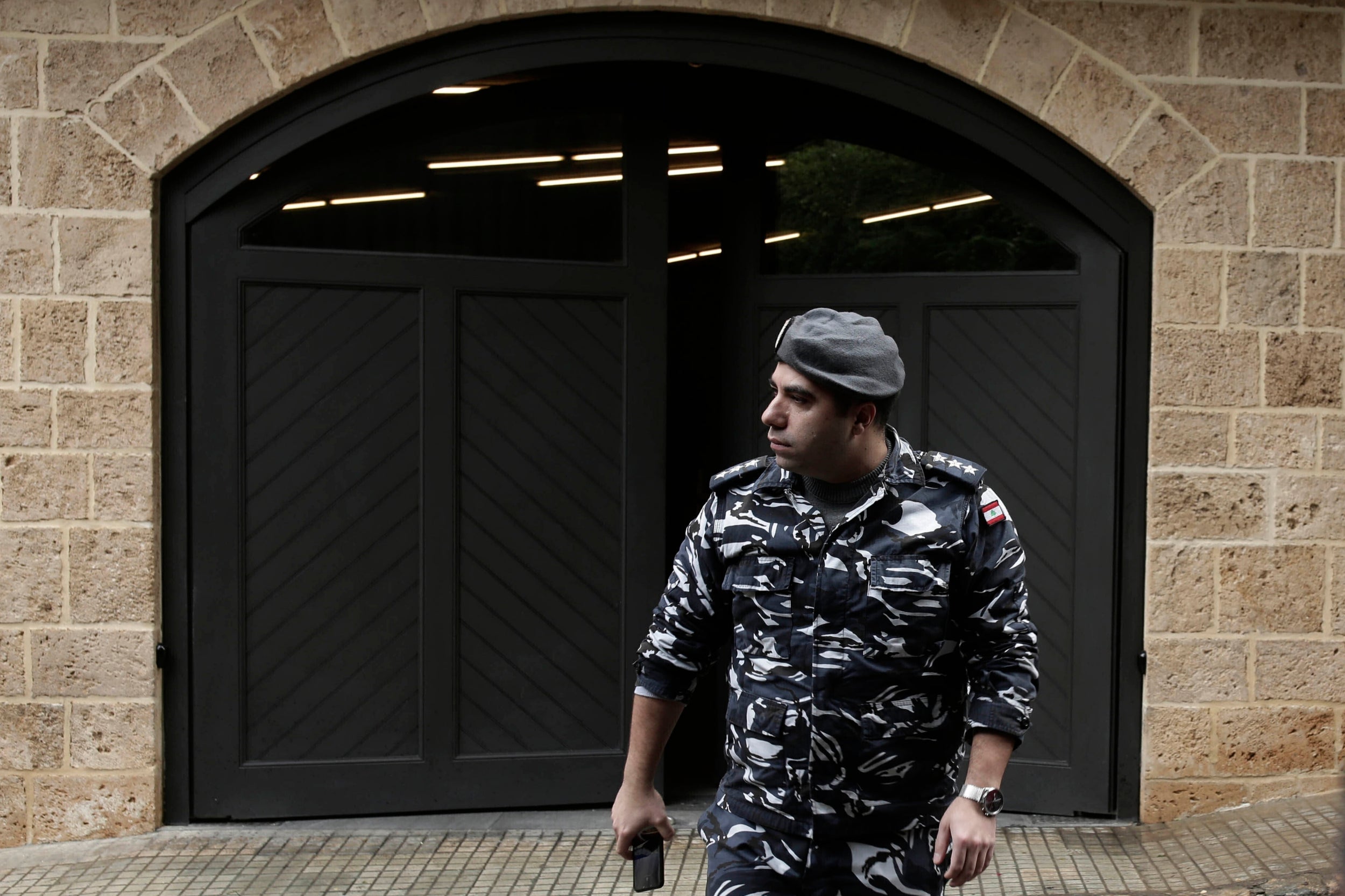 A policeman leaves the residence of Mr Ghosn last week in Beirut, Lebanon