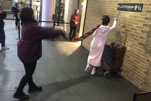 Weird world: tourists at King's Cross station in London, departure point for Harry Potter's Hogwarts Express