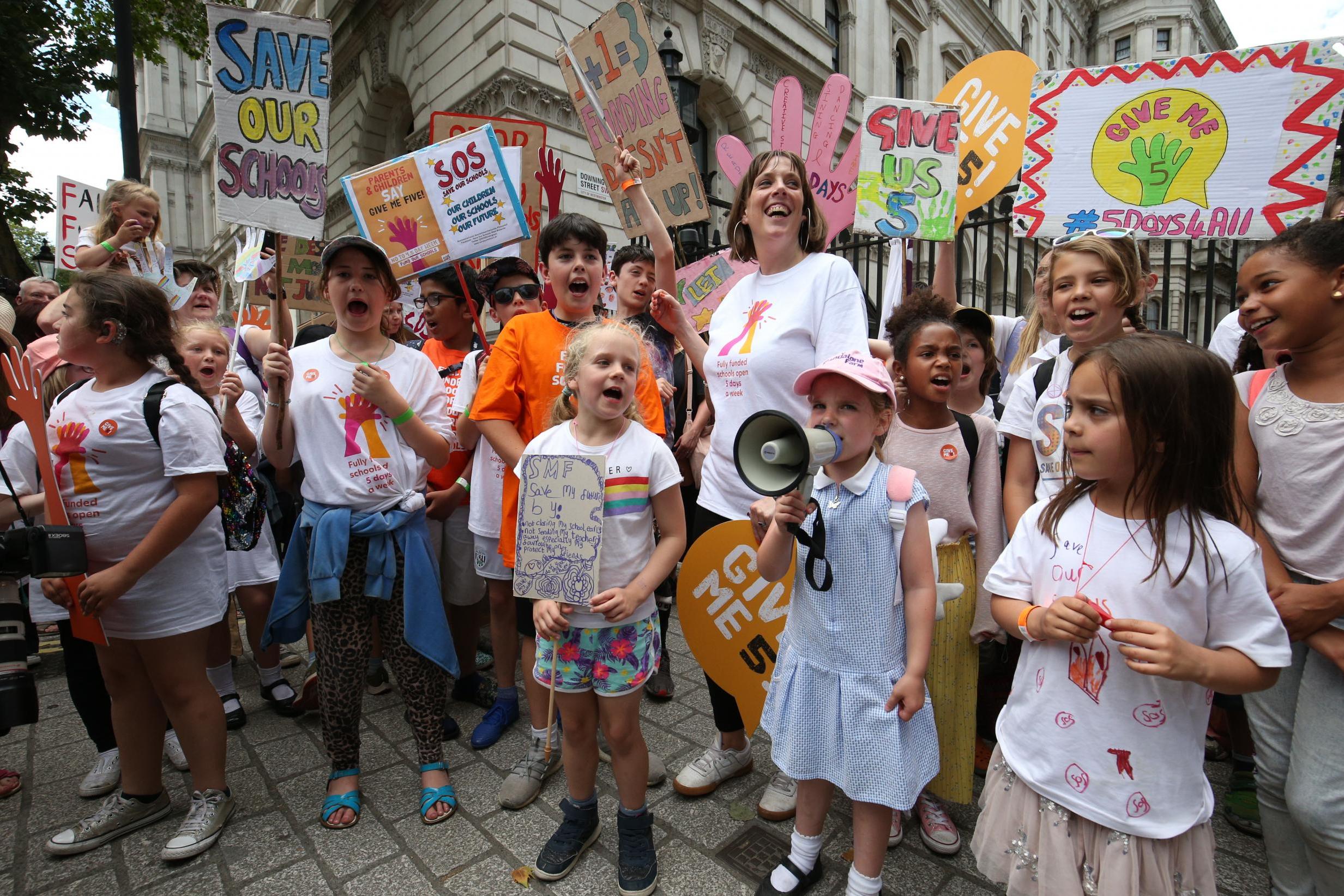 Jess Phillips joins a children’s protest over schools being forced to close early (PA Wire/PA)