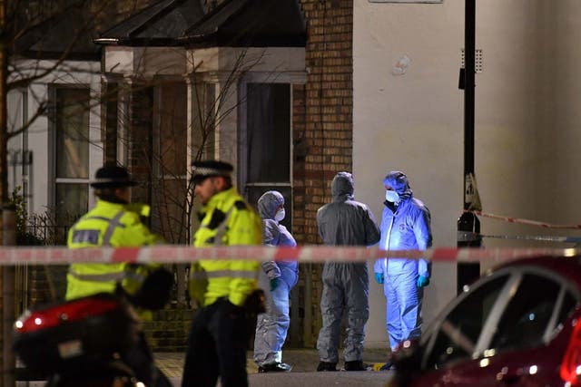 Forensic officers at the crime scene in Finsbury Park after a man was stabbed to death on Friday evening