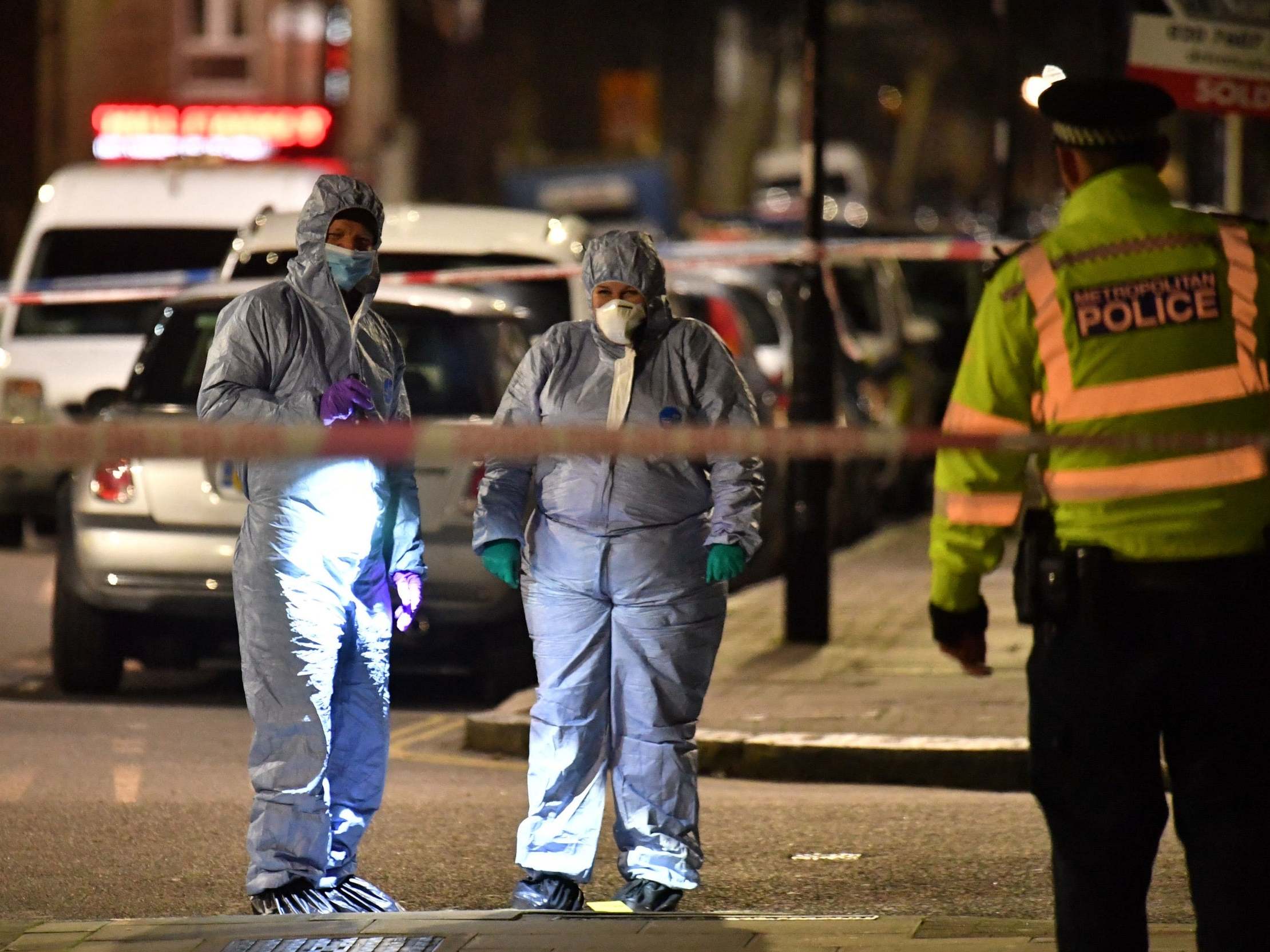 Forensic officers at the crime scene in Finsbury Park after a man was stabbed to death on Friday evening