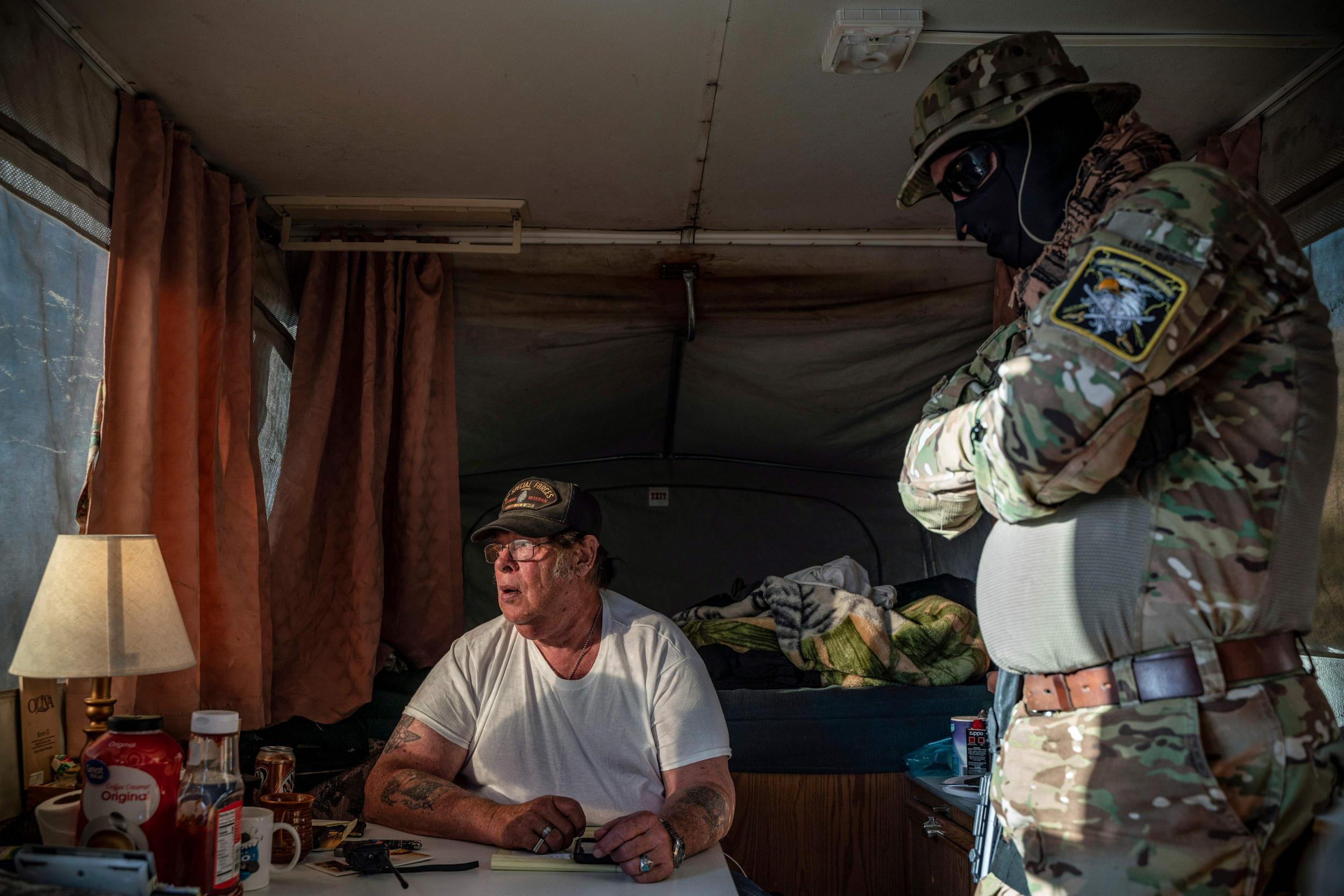 Hopkins discusses logistics on a group chat in a caravan near the Mexico border