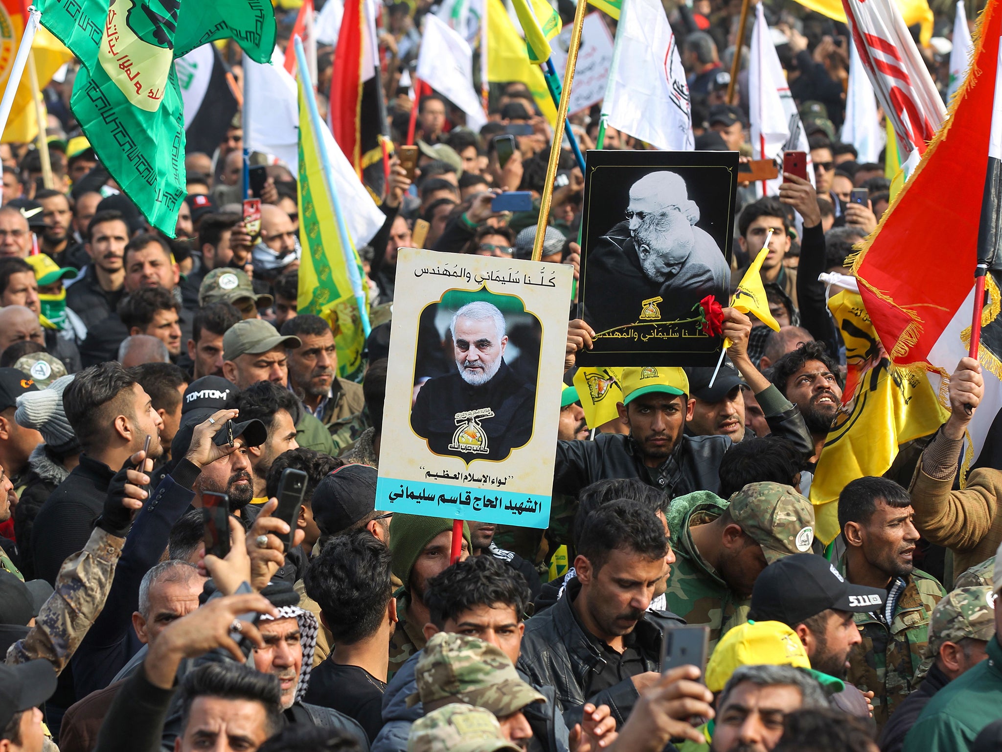 Supporters of the Hashed al-Shaabi paramilitary force and Iraq’s Hezbollah brigades attend the funeral