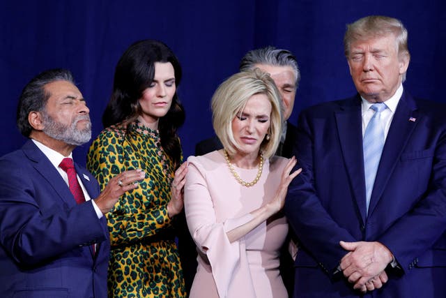 Donald Trump participates in a prayer for himself before speaking at an Evangelicals for Trump Coalition Launch