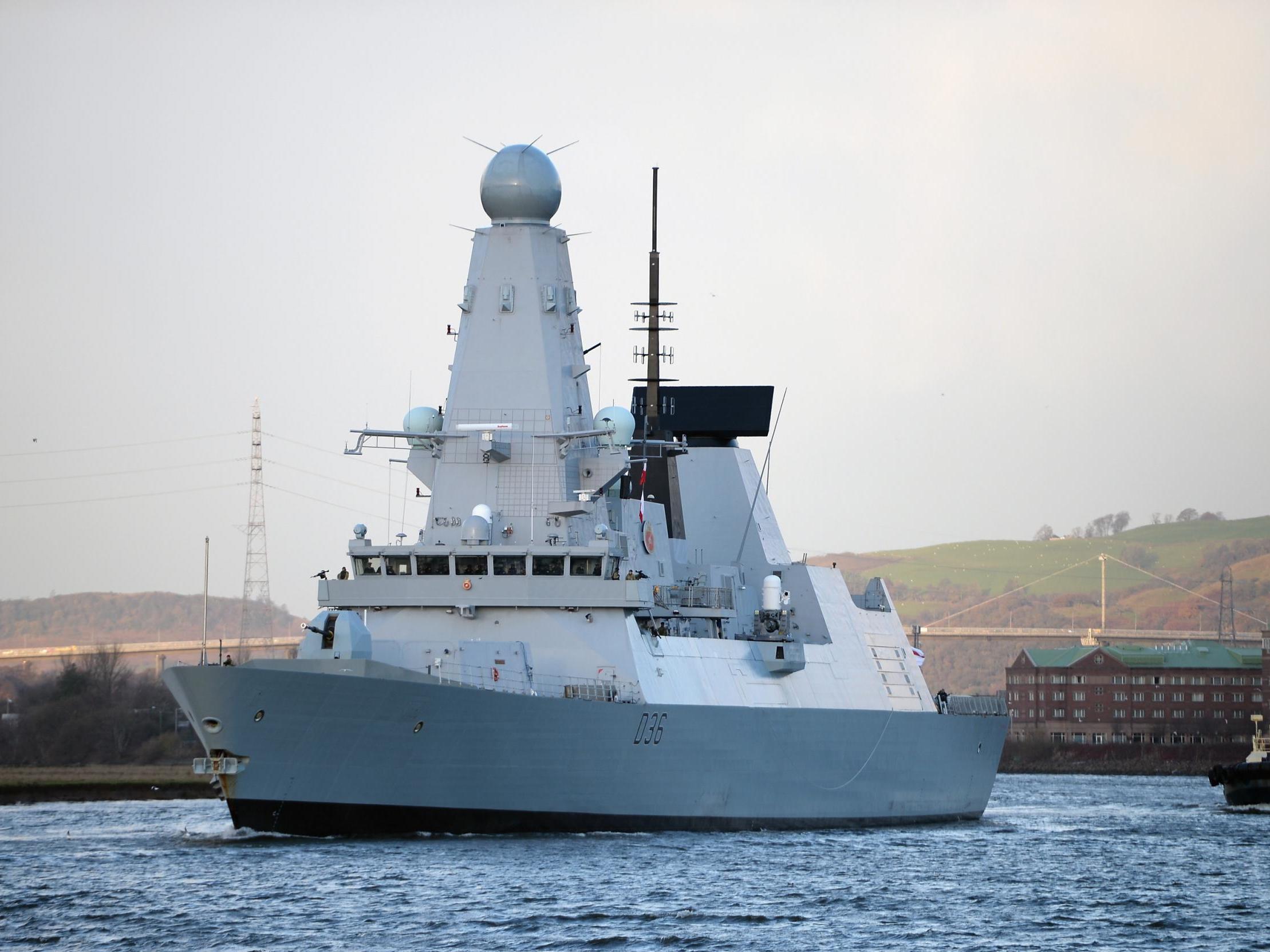 British warship HMS Defender makes its way up the River Clydeon in Glasgow, Scotland, in November 2013.