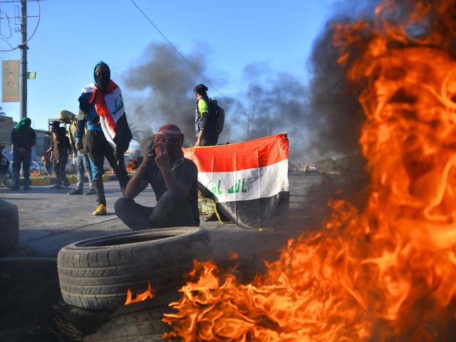 Iraqi demonstrators block a road with burning tyres in the central shrine city of Najaf, on 5 January 2020, to protest turning the country into an arena for US-Iran conflicts