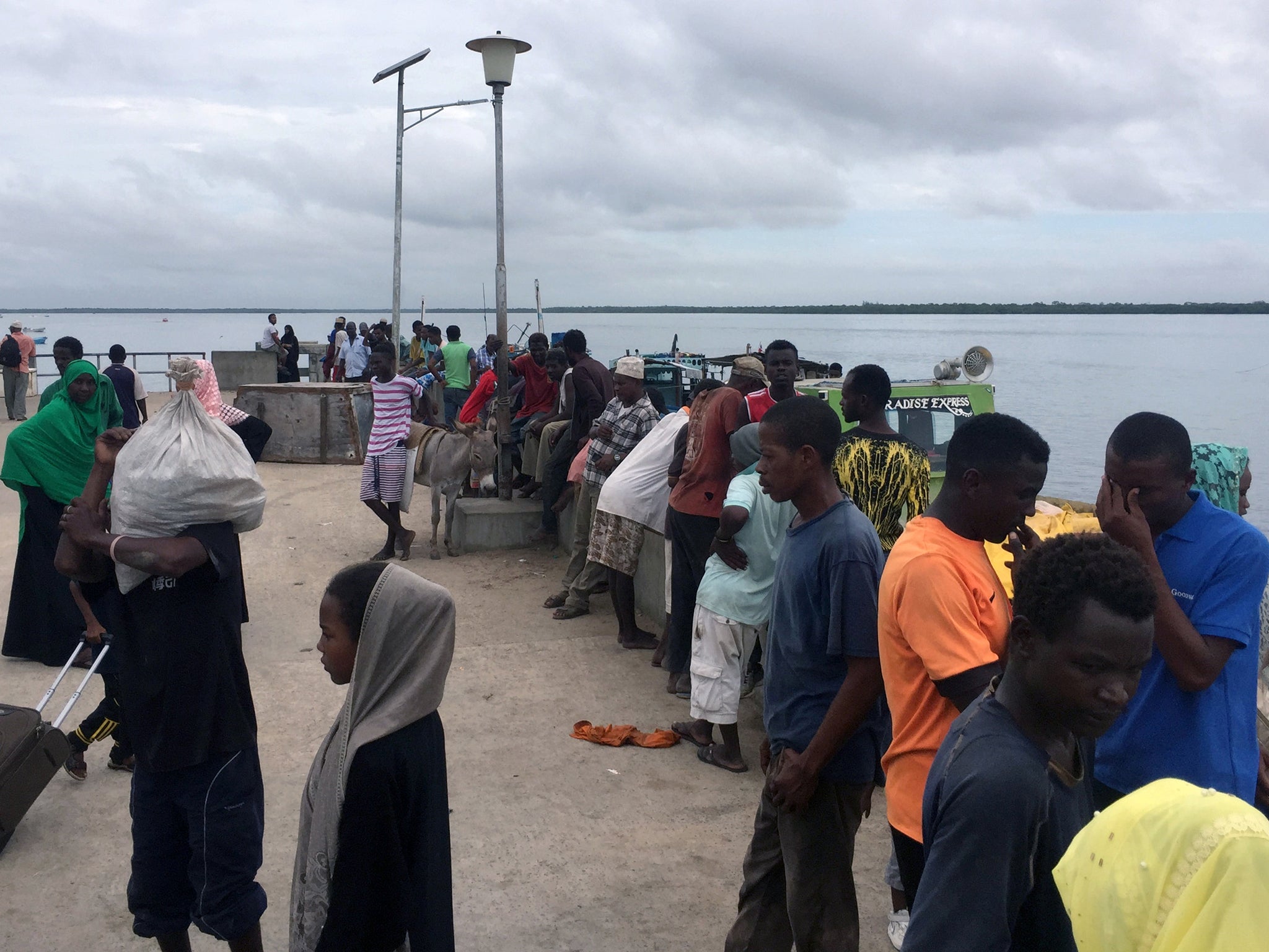Travellers gather at the Lamu jetty following the attack