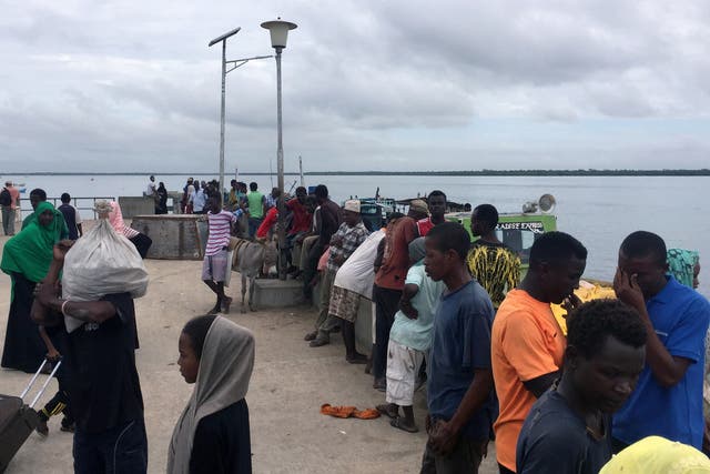 Travellers gather at the Lamu jetty following the attack