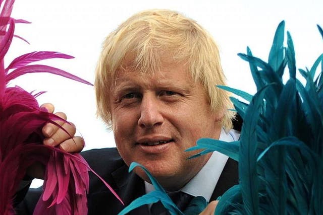 Boris Johnson poses with costumed masqueraders from the Genesis Mas ban