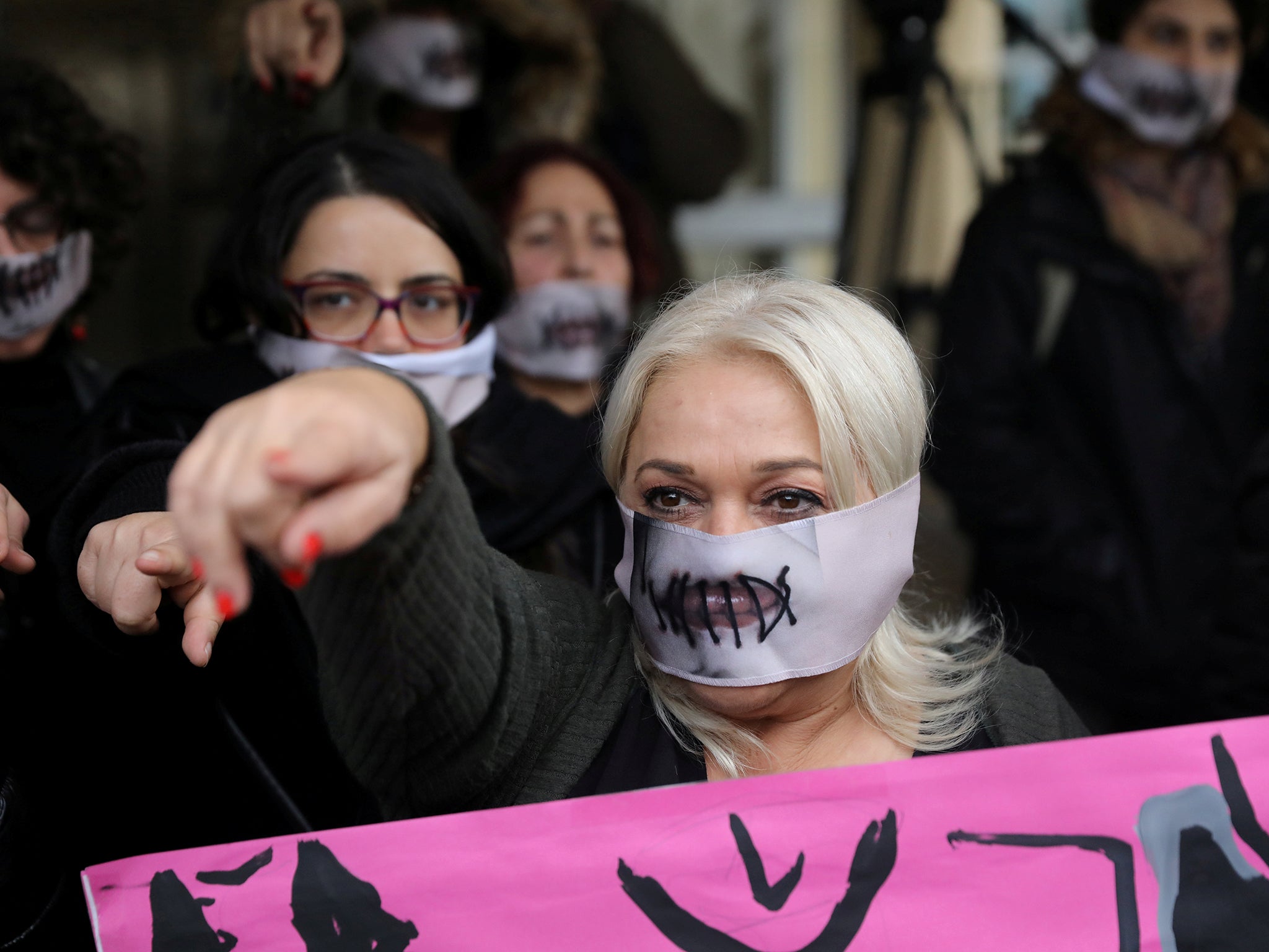 Activists take part in a demonstration outside the Famagusta courthouse in Paralimni