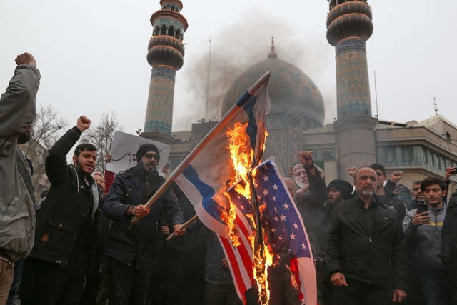 Iranians burn US and Israeli flags during an anti-US protest over the killings during a US air strike of Iranian military commander Qasem Soleimani and Iraqi paramilitary chief Abu Mahdi al-Muhandis, in the capital Tehran on January 4