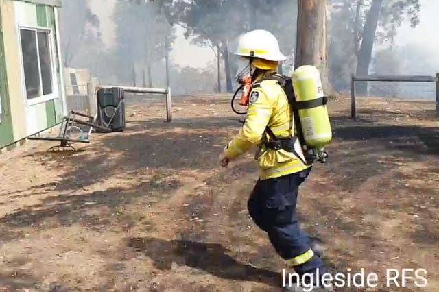 Tony Abbott has been filmed running to extinguish a house fire in Bendalong, New South Wales