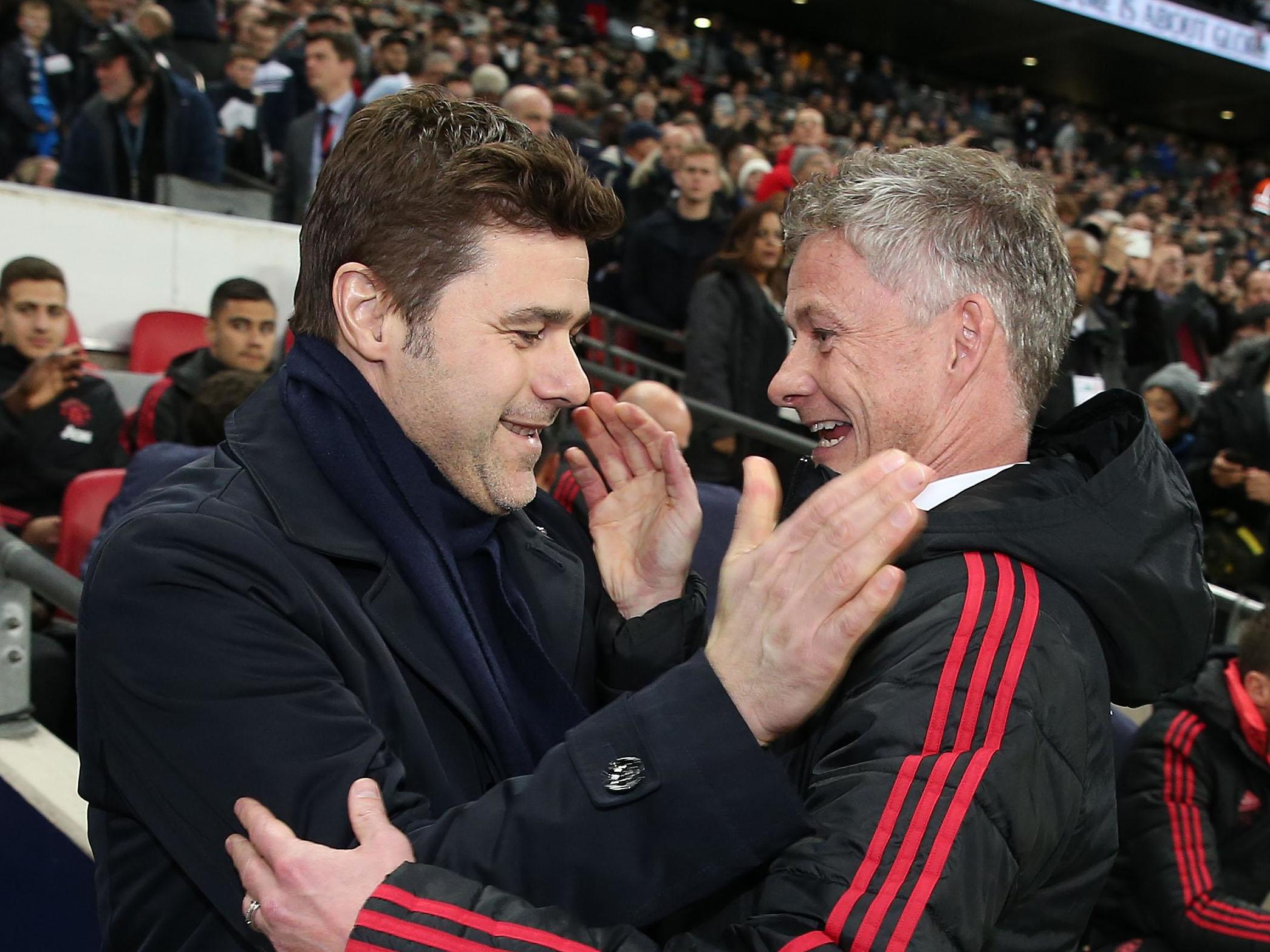 Manager Mauricio Pochettino of Tottenham Hotspur greets Caretaker Manager Ole Gunnar Solskjaer of Manchester United