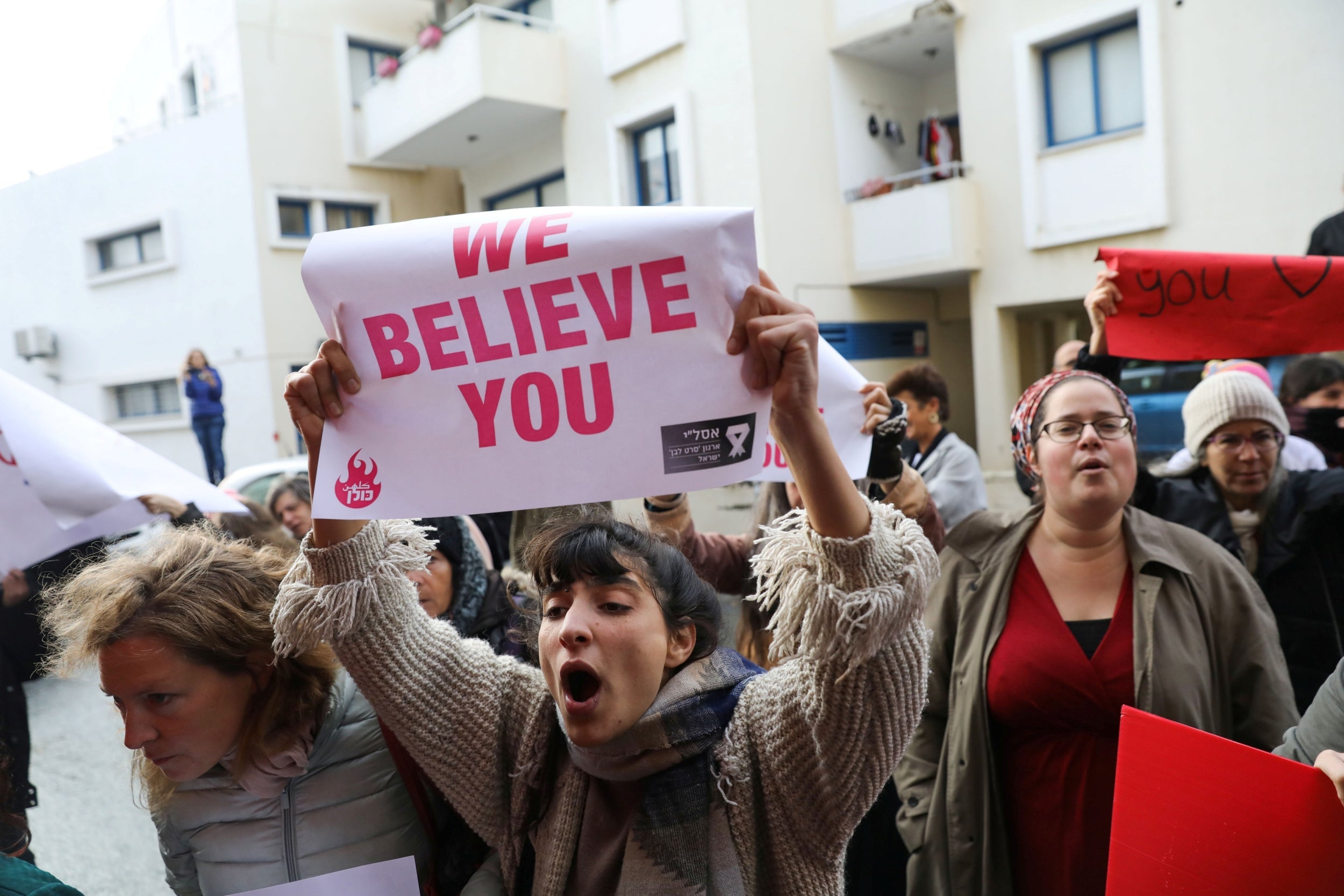 Demonstrators voice support for the British woman accused of lying about a gang rape as she arrives at court in Paralimni