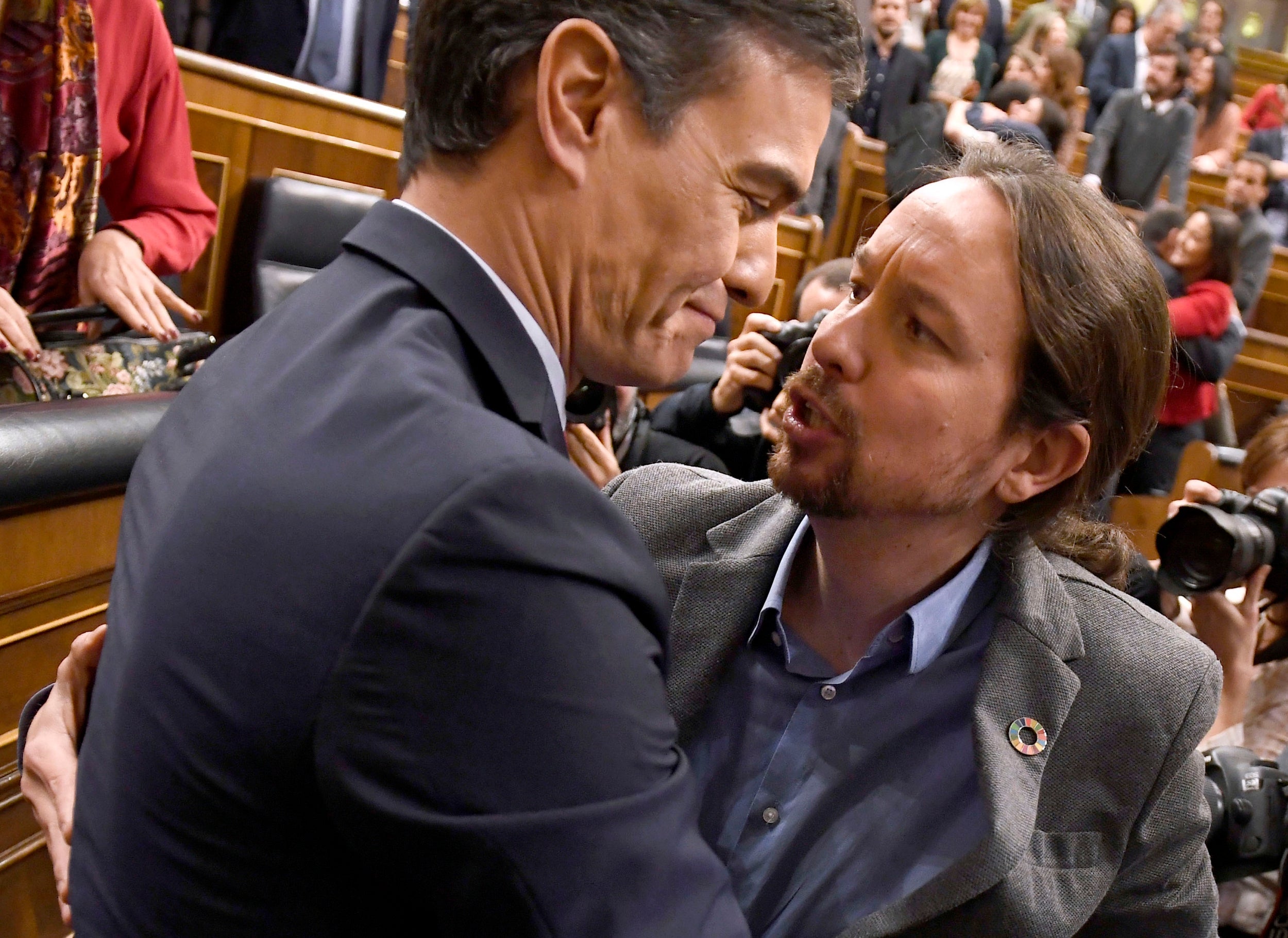 PSOE leader Pedro Sanchez is congratulated by Spanish left-wing Unidas Podemos leader Pablo Iglesias