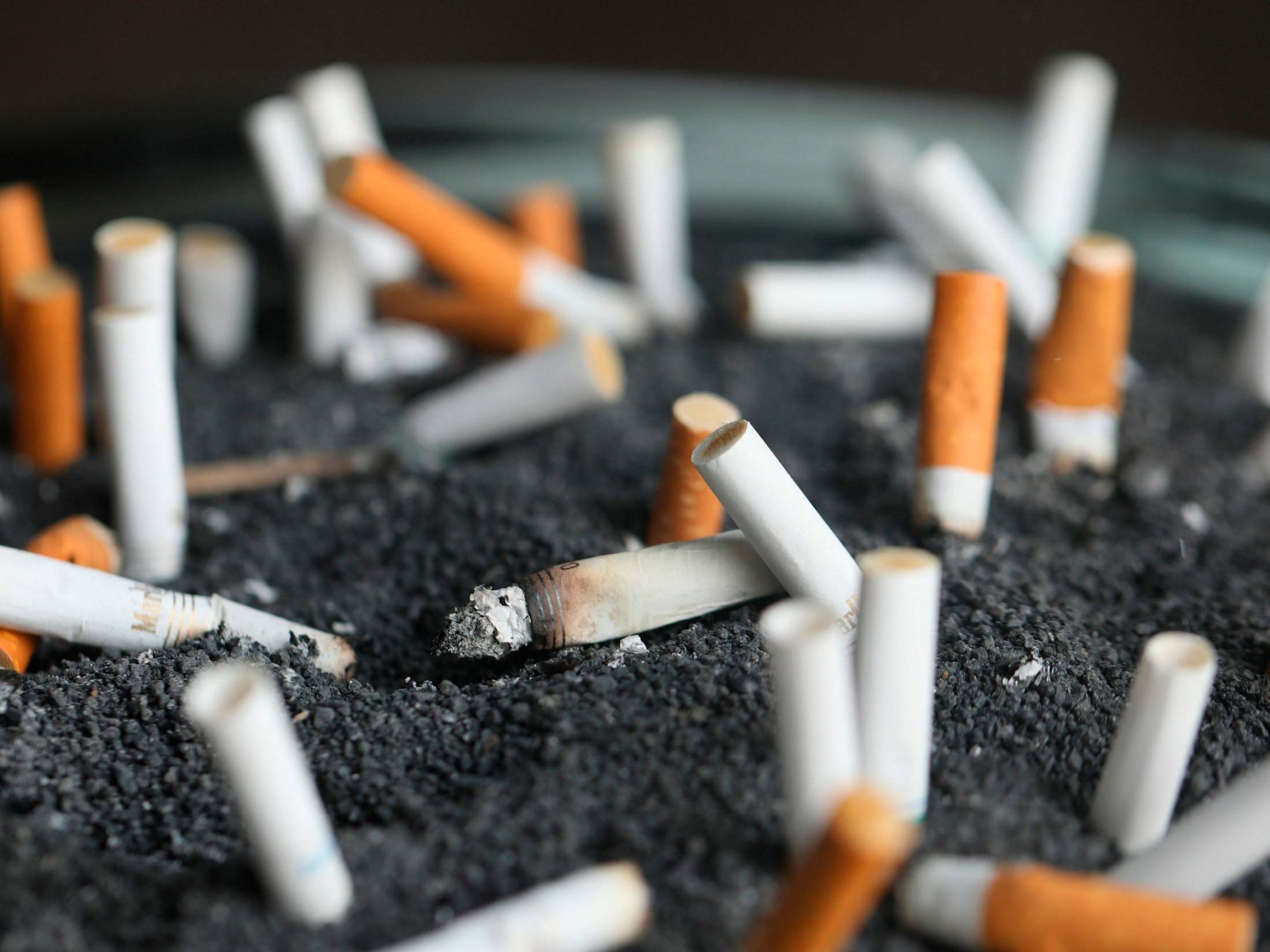 This 28 March 2019 photo shows cigarette butts in an ashtray in New York. On 8 January 2020, researchers reported the largest-ever decline in the US cancer death rate, and they are crediting advances in the treatment of lung tumors