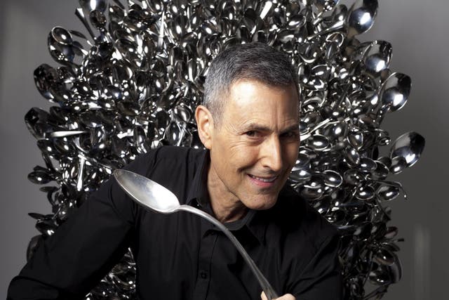 Uri Geller sits on a throne of spoons inspired by the television show Game of Thrones