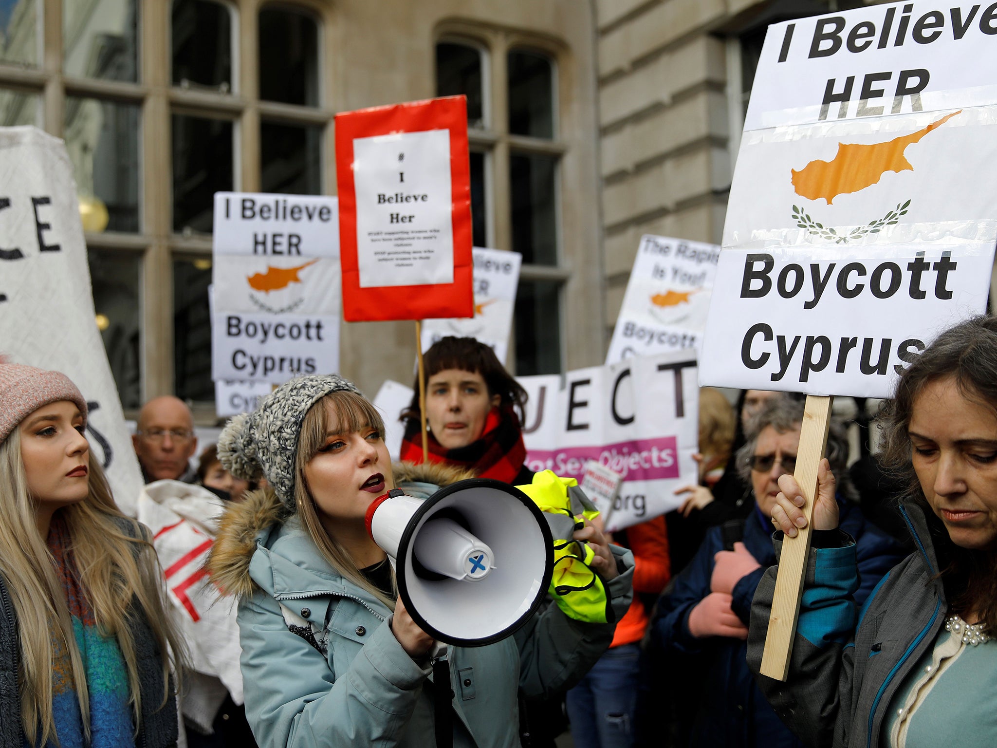 Demonstrators hold placards calling for a boycott on Cyprus as they protest in London