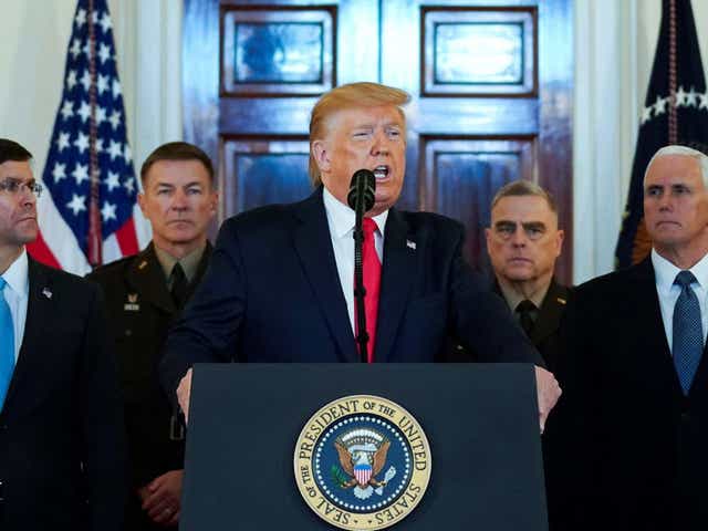 US president Donald Trump delivers a statement about Iran flanked by officials