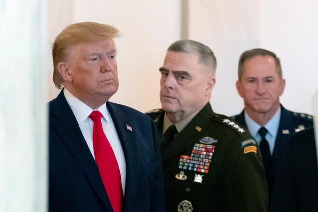 Donald Trump, flanked by Mark Milley, chairman of the joint chiefs of staff, centre, and David Goldfein, Air Force chief of staff, right, prepares to read a statement on tensions with Iran