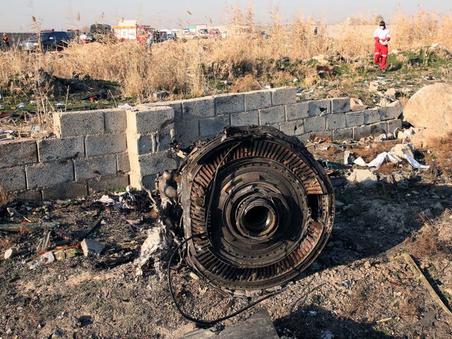 One of the engines of the plane lies among the wreckage after a Boeing 737-800 carrying 176 people crashed
