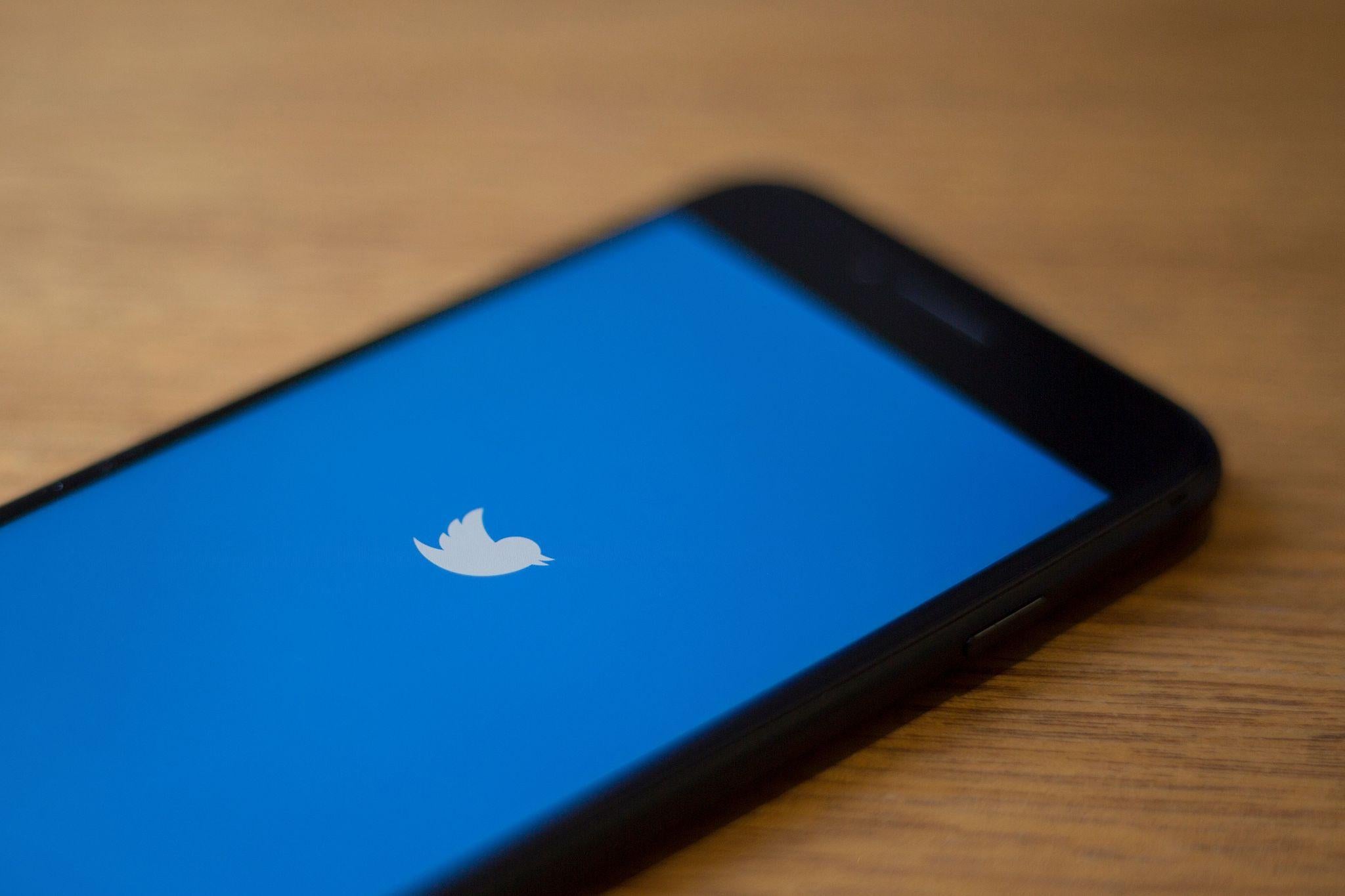 The Twitter logo is seen on a phone in this photo illustration in Washington, DC, on July 10, 2019