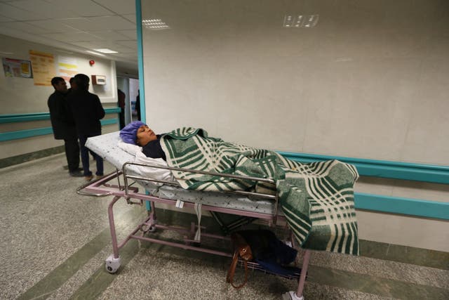 An Iranian woman wounded in a stampede that broke out at the funeral of Qasem Soleimani hometown lies in a hospital bed in the southeastern city of Kerman on 7 January 2020