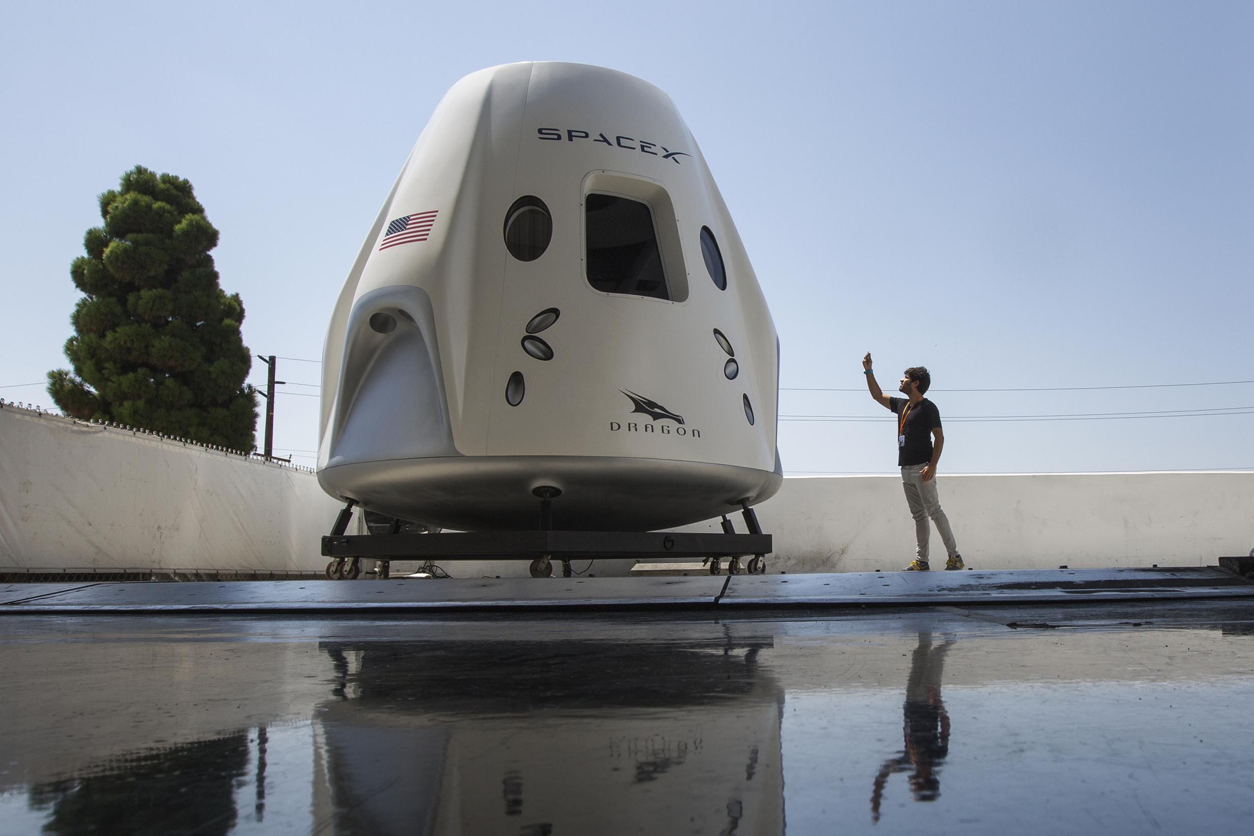 SpaceX aims to launch astronauts this spring after a successful escape test of its Crew Dragon reusable spacecraft