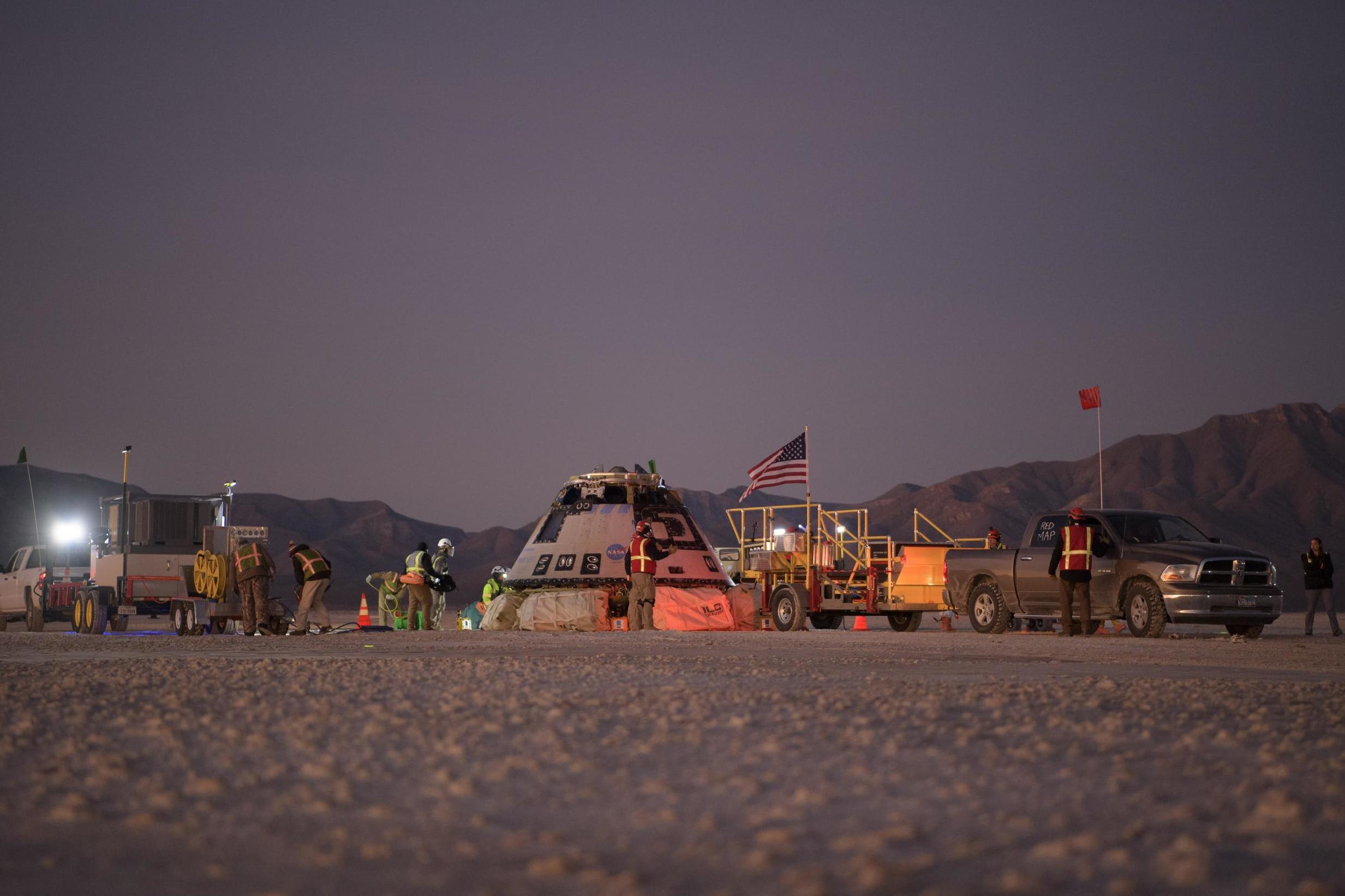 Boeing, Nasa, and army personnel work on the Boeing Starliner shortly after it landed in White Sands in 2019 (Getty)