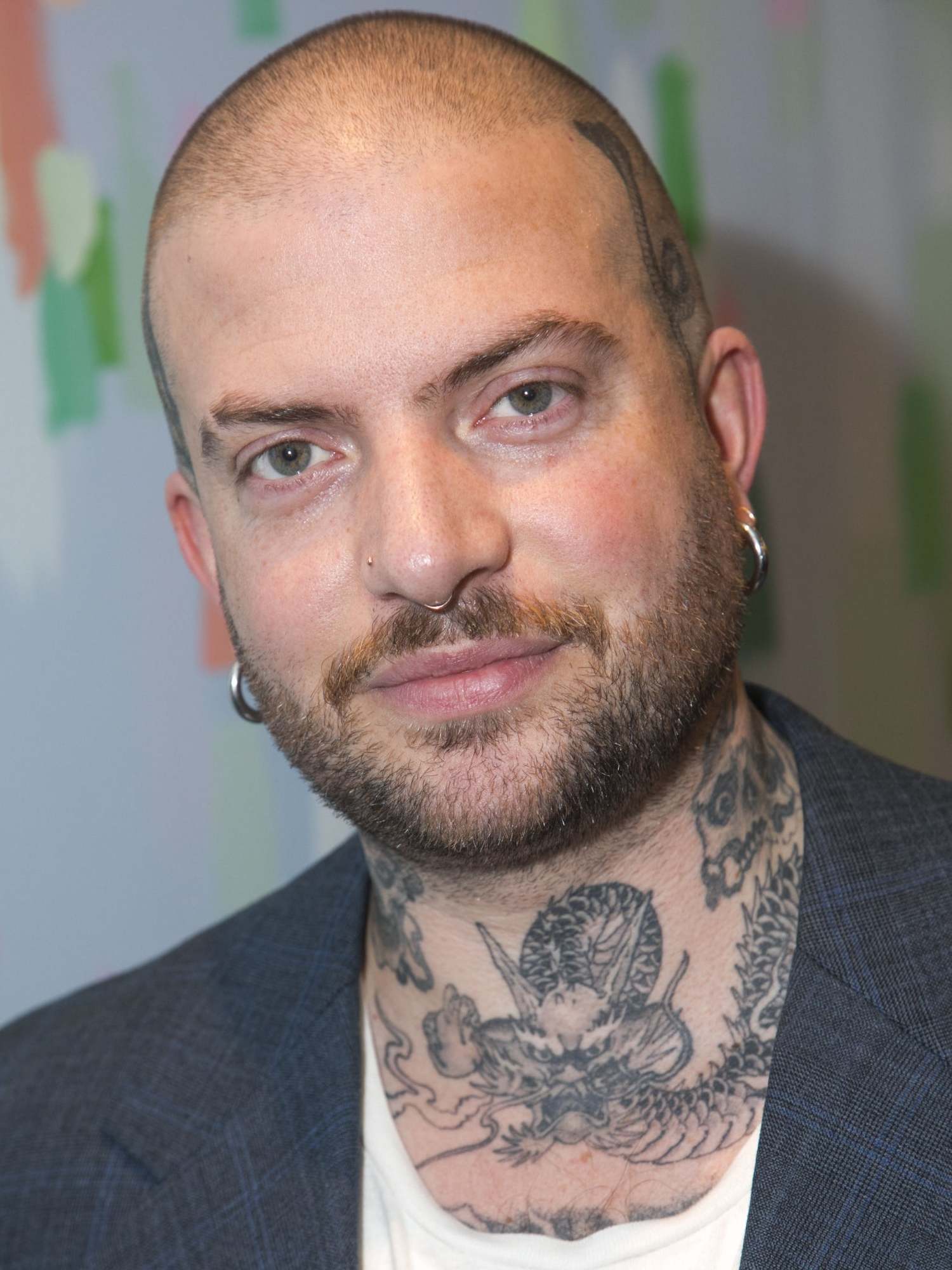 Lloyd’s tattoos give the director his distinctive look