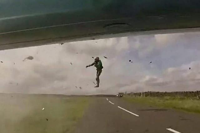 A motorcyclist flies into the air after being hit by a speeding motorist driving on the wrong side of the road