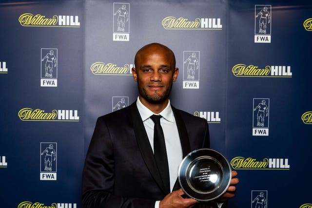 Vincent Kompany poses an award from the Football Writers' Association on Sunday