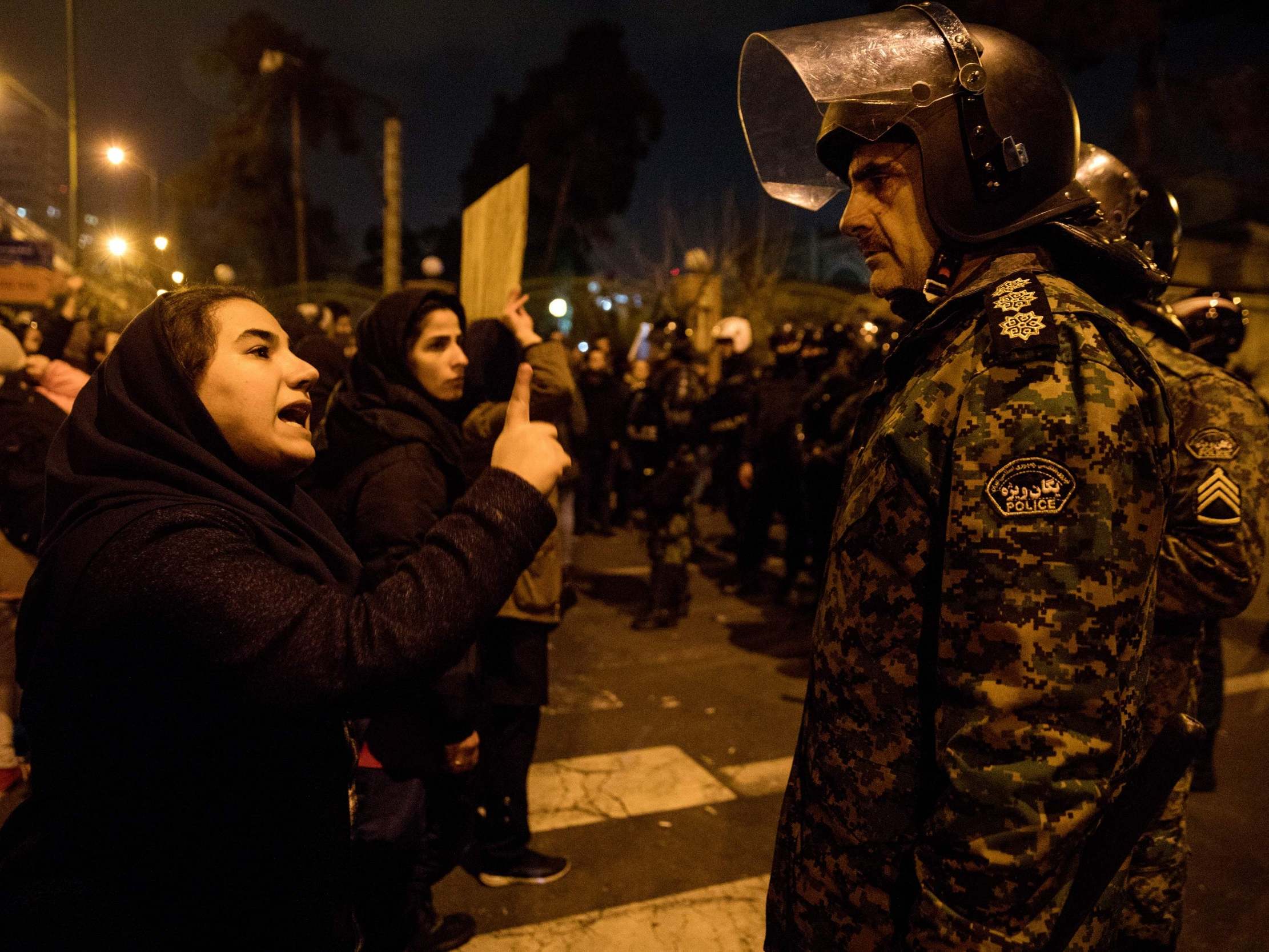A woman attending a candlelight vigil in memory of the victims of Ukraine International Airlines Boeing 737 confronts a policeman