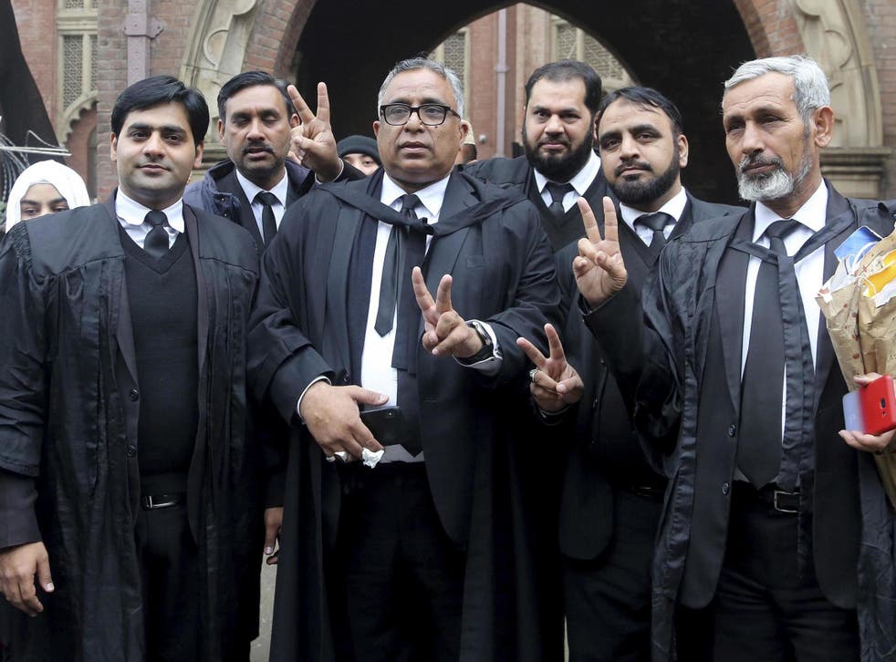 Mohammad Azhar Siddique, center, a lawyer for former Pakistani President and military ruler Pervez Musharraf, and other lawyers make a victory sign after the court decision in Lahore Jan 13 2020