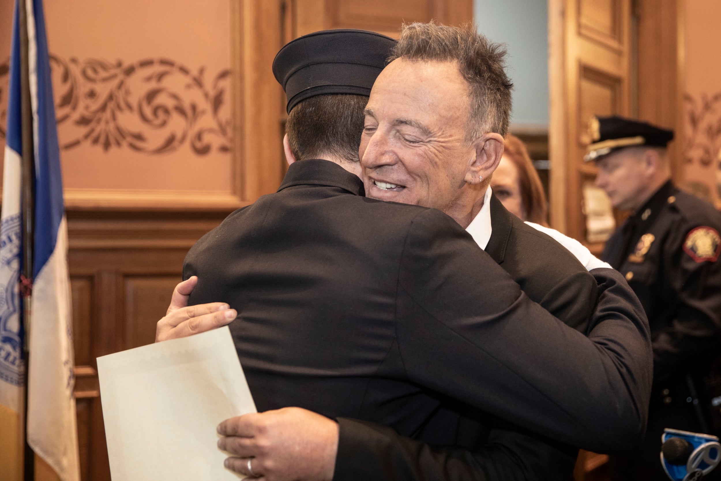 Bruce Springsteen hugs his son, Sam, after he was sworn in as a Jersey City firefighter
