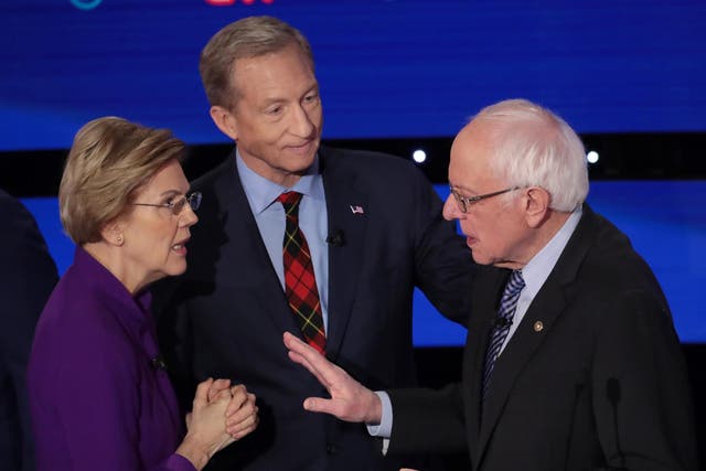 Elizabeth Warren and Bernie Sanders speak as Tom Steyer looks on after the Democratic presidential primary debate in Des Moines