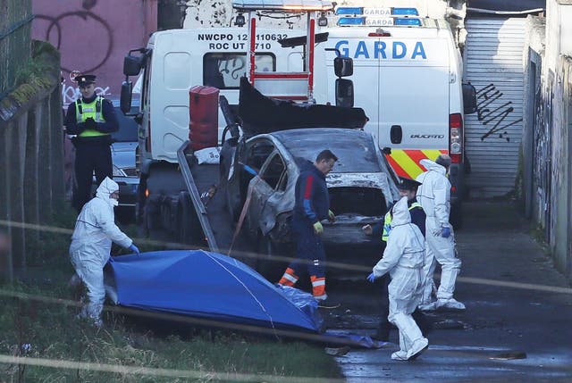 A burnt out car which contained human remains, believed to be linked to the disappearance of a 17-year-old boy from Co Louth, is removed from the scene on Trinity Terrace in the Drumcondra area of Dublin