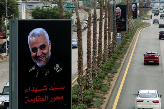 Cars pass a picture of the late Iranian general Qassem Soleimani in the suburbs of Beirut after his killing by a US drone strike