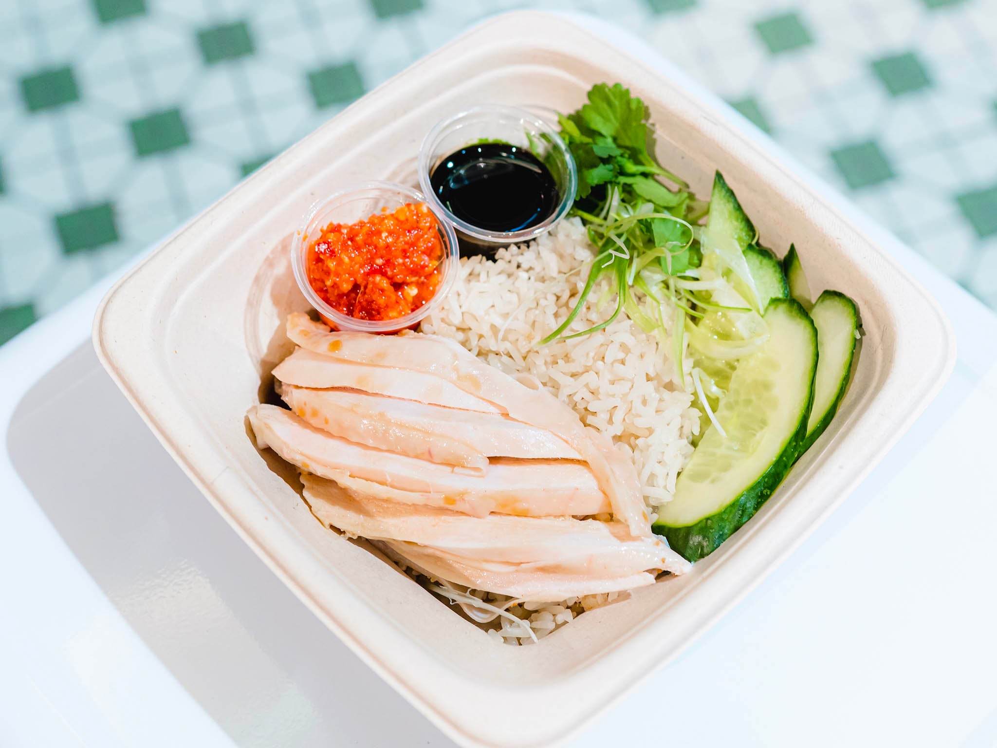 Hainanese chicken rice is a simple dish, with poached meat and usually served with cucumber