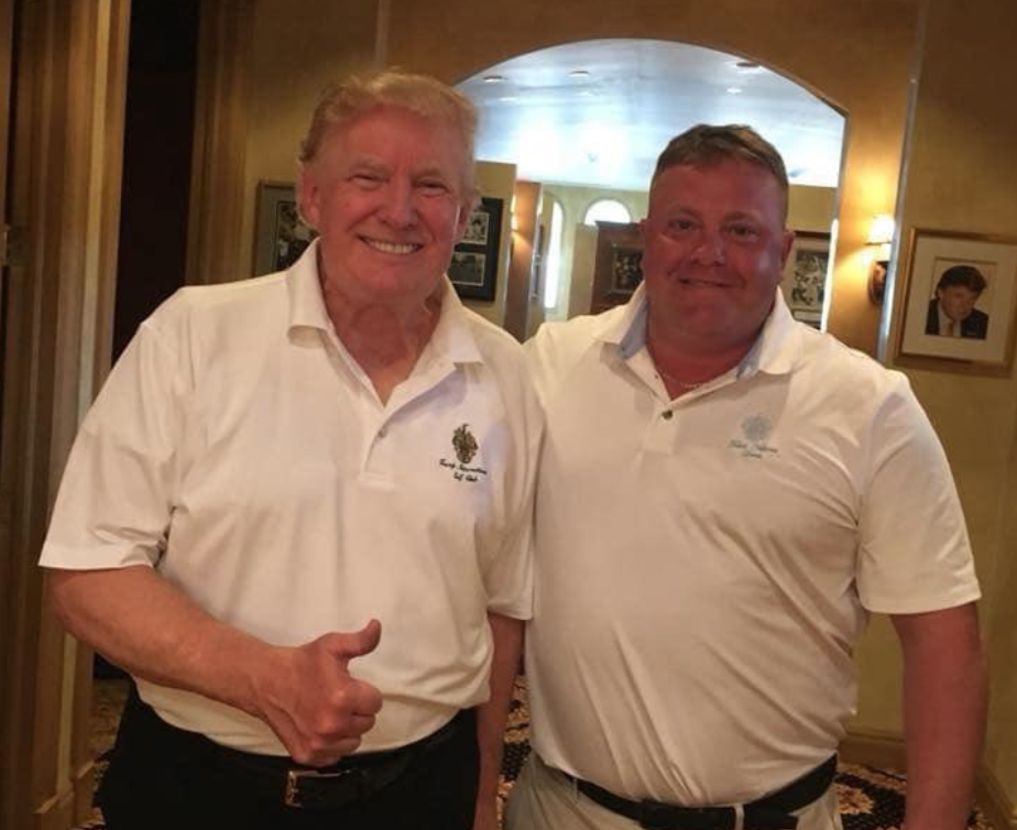 Donald Trump poses for a photograph with Robert Hyde, a Republican lobbyist who has found himself at the heart of explosive new revelations surrounding the president's impeachment.