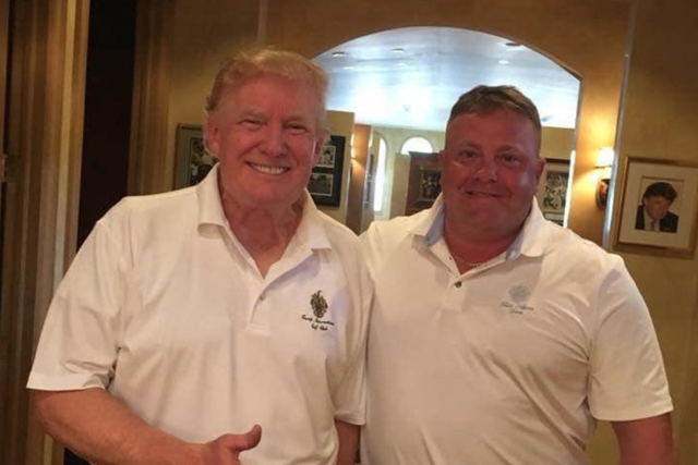 Donald Trump poses for a photograph with Robert Hyde, a Republican lobbyist who has found himself at the heart of explosive new revelations surrounding the president's impeachment.