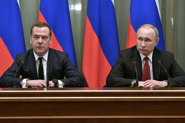Vladimir Putin and Dmitry Medvedev attend a meeting with members of the government in Moscow