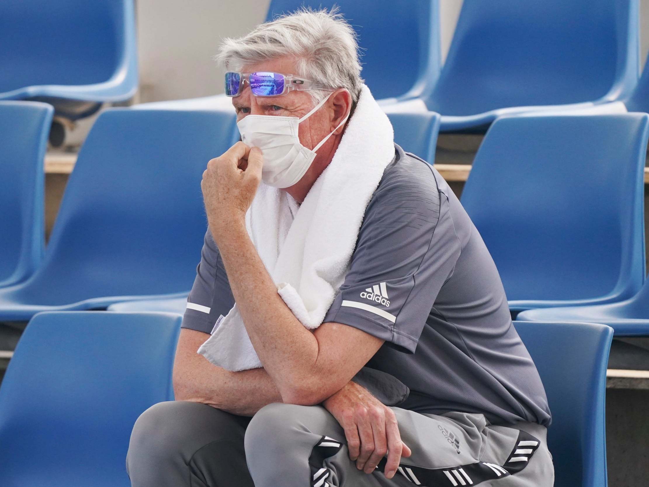 A spectator wears a mask as smoke haze shrouds Melbourne