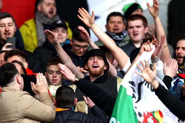 Oli McBurnie stands in the away end with Swansea City supporters