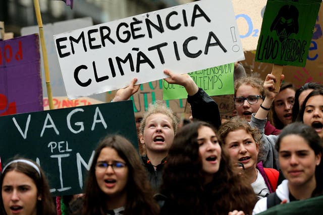 Young Spanish climate activists shout slogans while holding a sign reading "Climate emergency" during a demonstration in Barcelona May 24 2019 Pau Barrena
