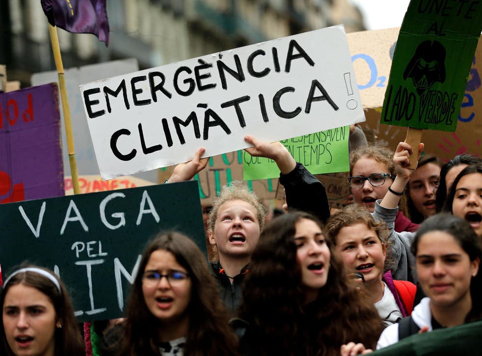 Young Spanish climate activists shout slogans while holding a sign reading "Climate emergency" during a demonstration in Barcelona May 24 2019 Pau Barrena