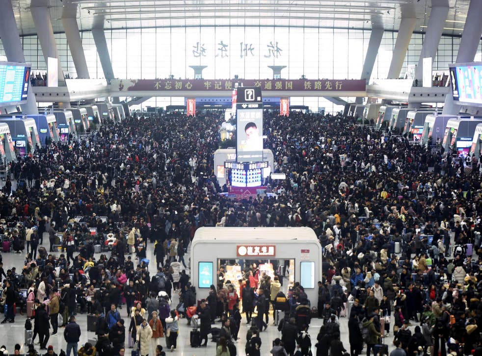 Passengers wait for their trains at the Hangzhou East Railway Station