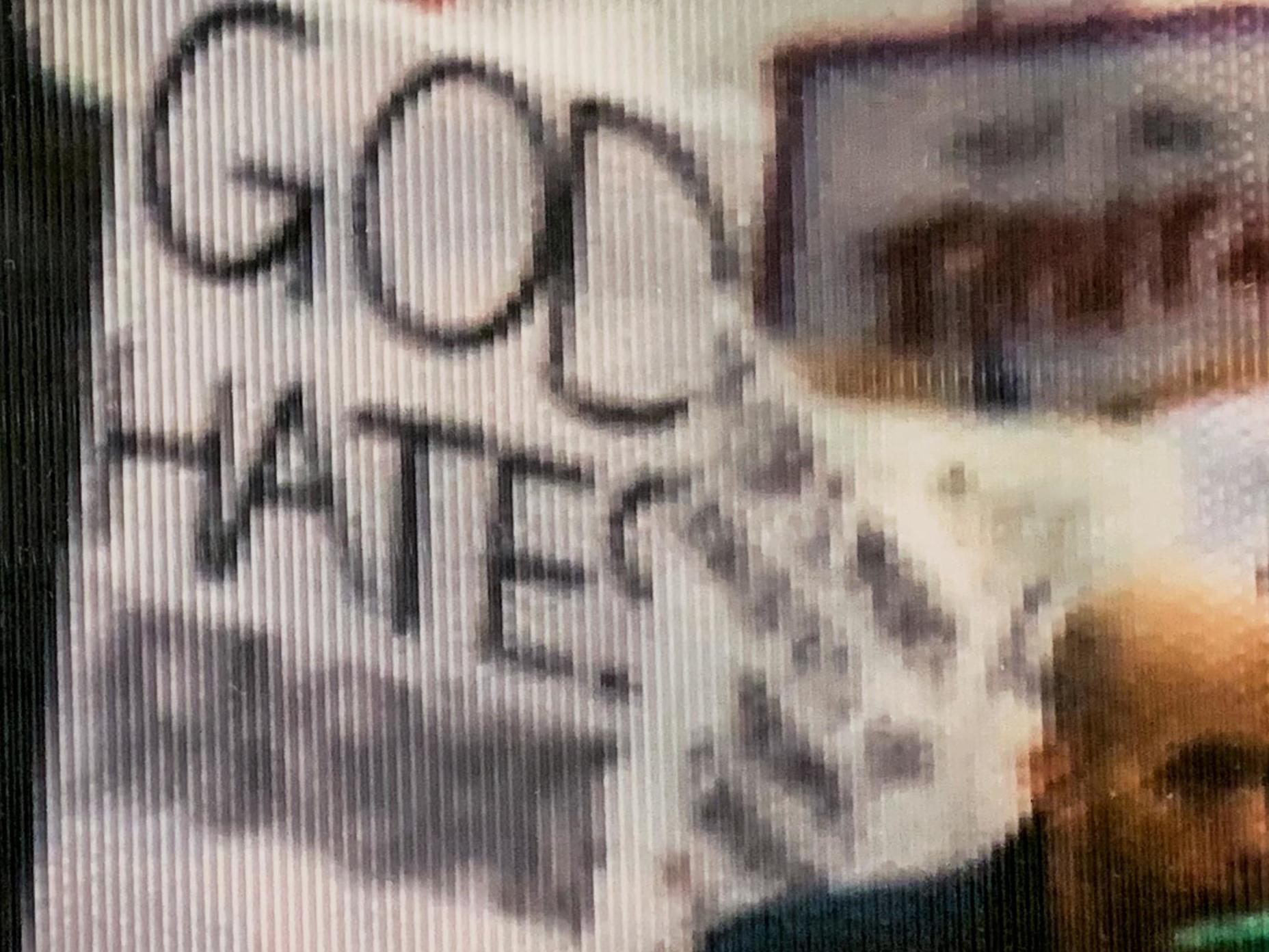 This is a close-up of an altered sign in a photograph from the Women's March in 2017 that is on display at the National Archives in Washington DC Salwan Geroges