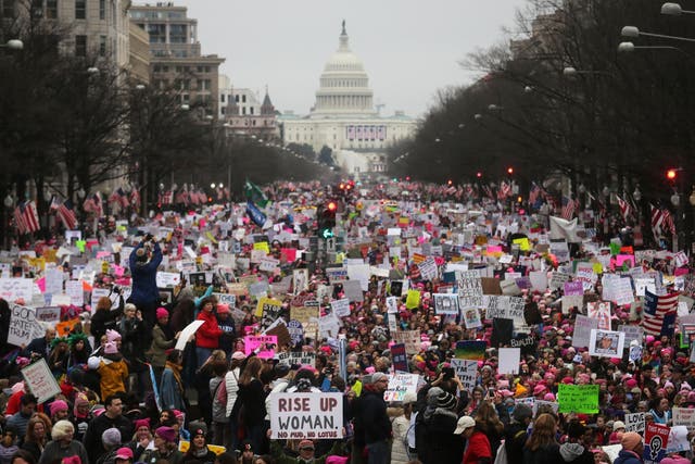 Protesters walk during the Women's March on Washington, with the U.S. Capitol in the background, on January 21, 2017 in Washington DC Mario Tama/Getty Images